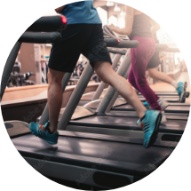 people running on treadmills in gym