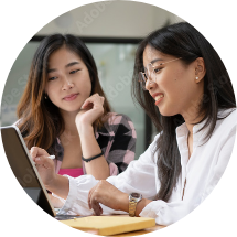 Two Asian girls looking at a laptop