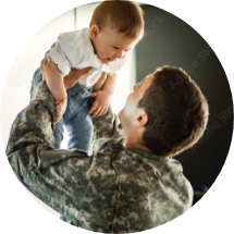 Military man holding child