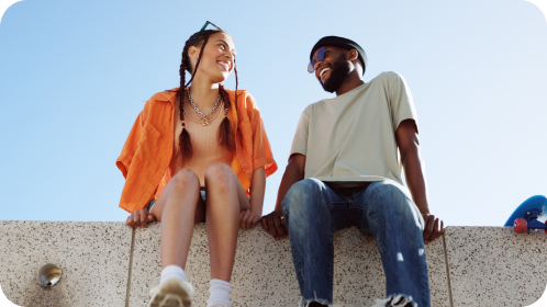 Two students sitting and smiling together. 