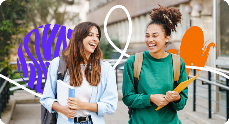 Two students smile and walk together.