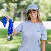 A person standing outside holding medals