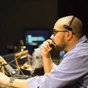 A person sitting and using a headset