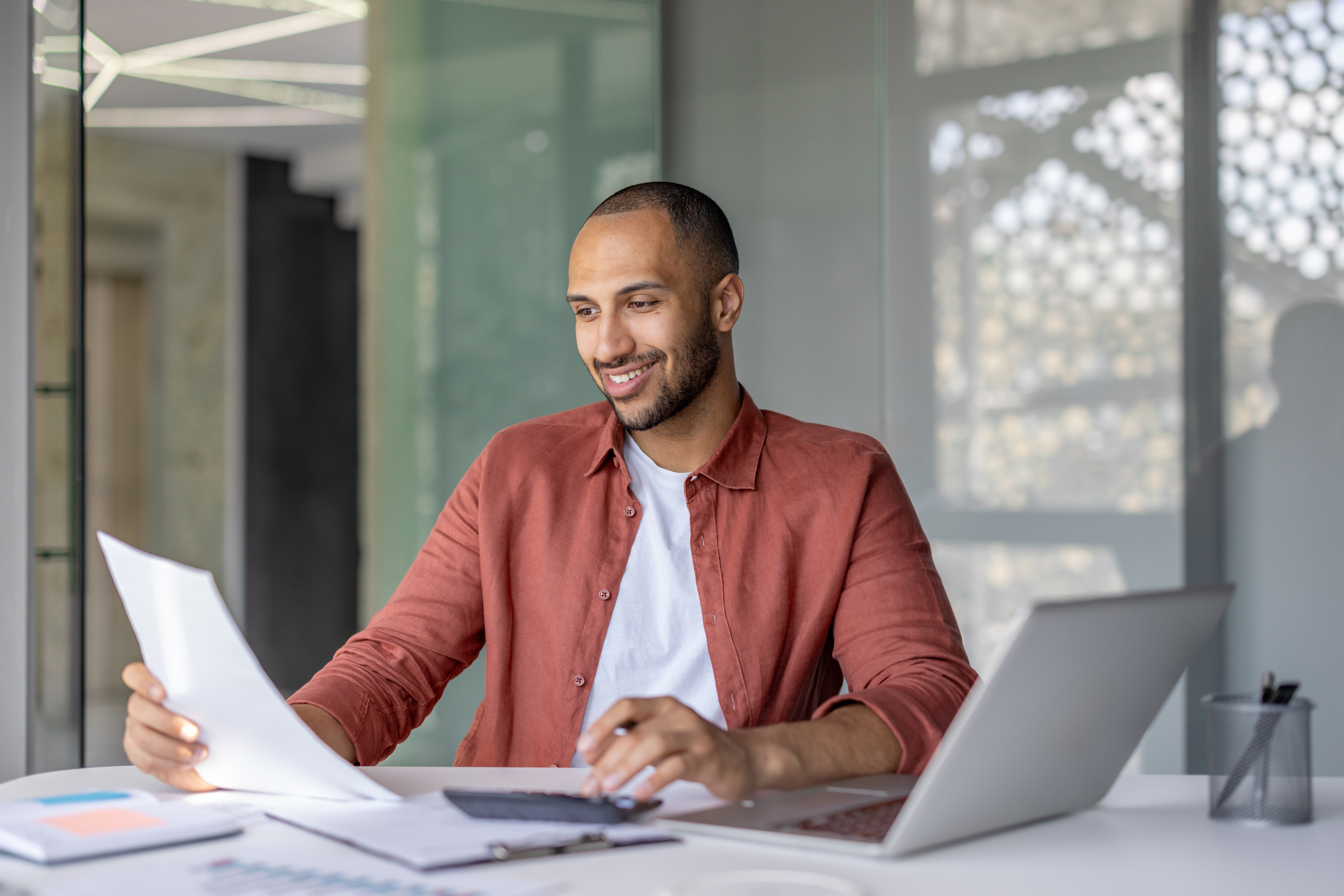 adult-looking-over-documents-at-their-desk