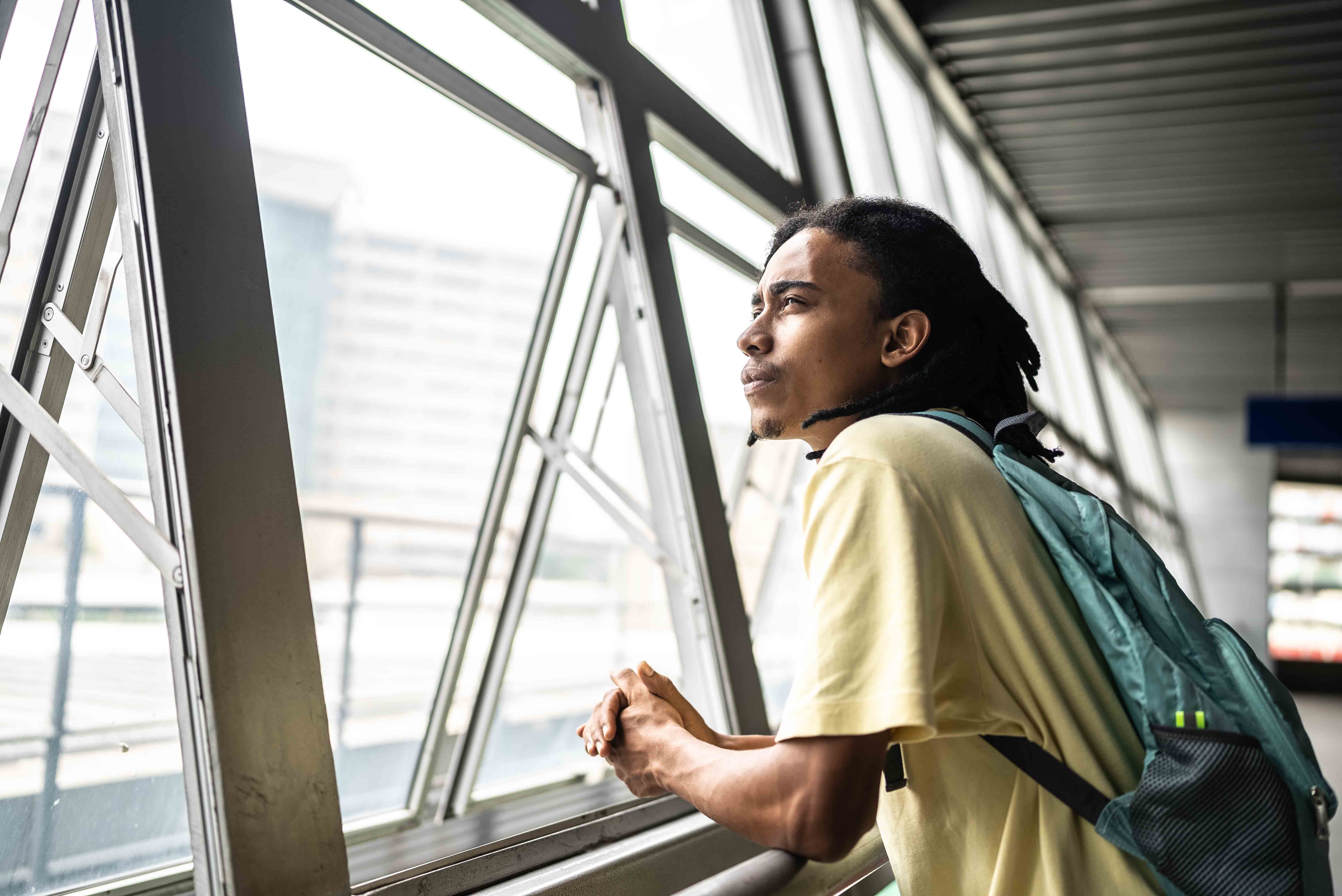 Contemplative student looking out window.