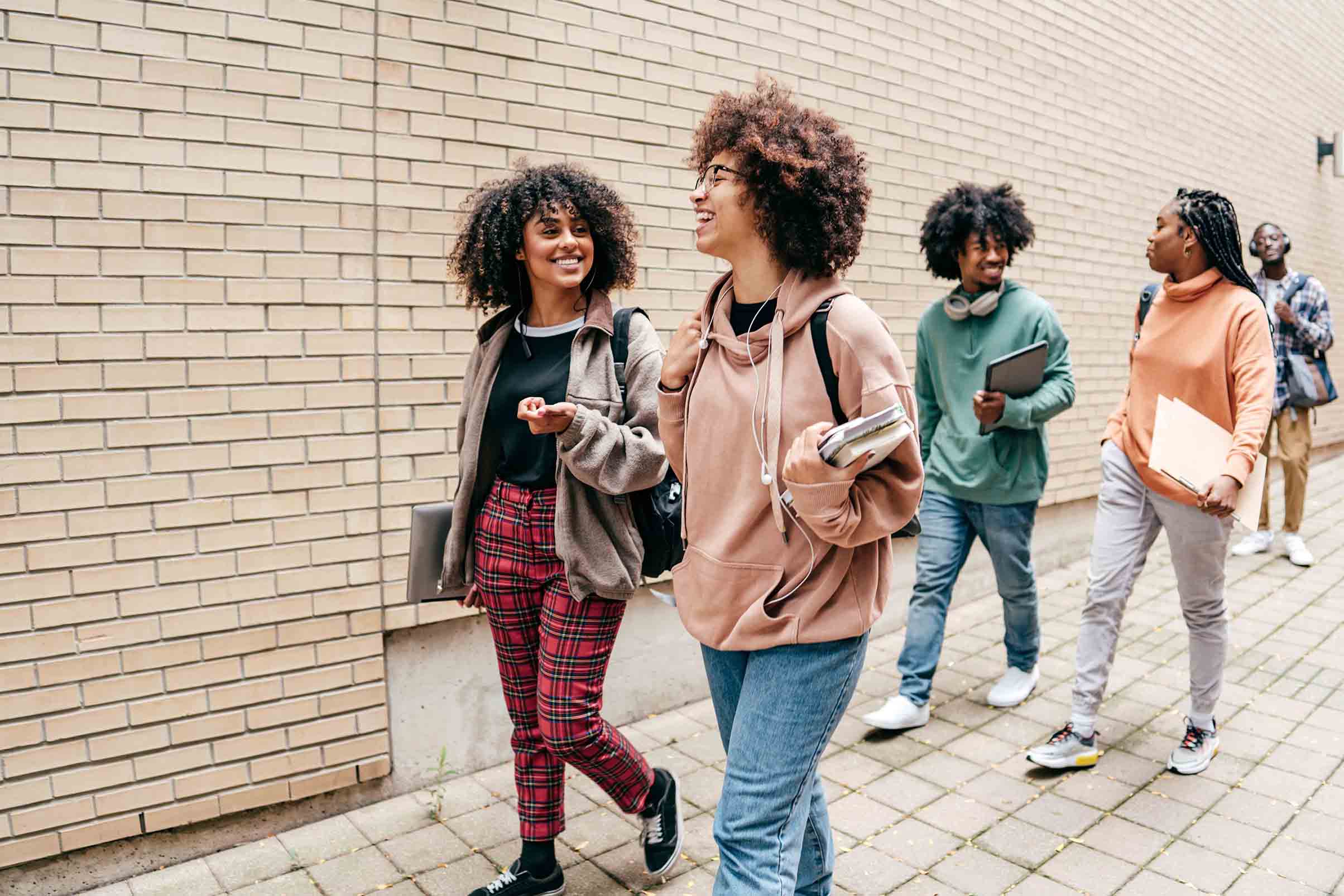 Friends walking on campus together.