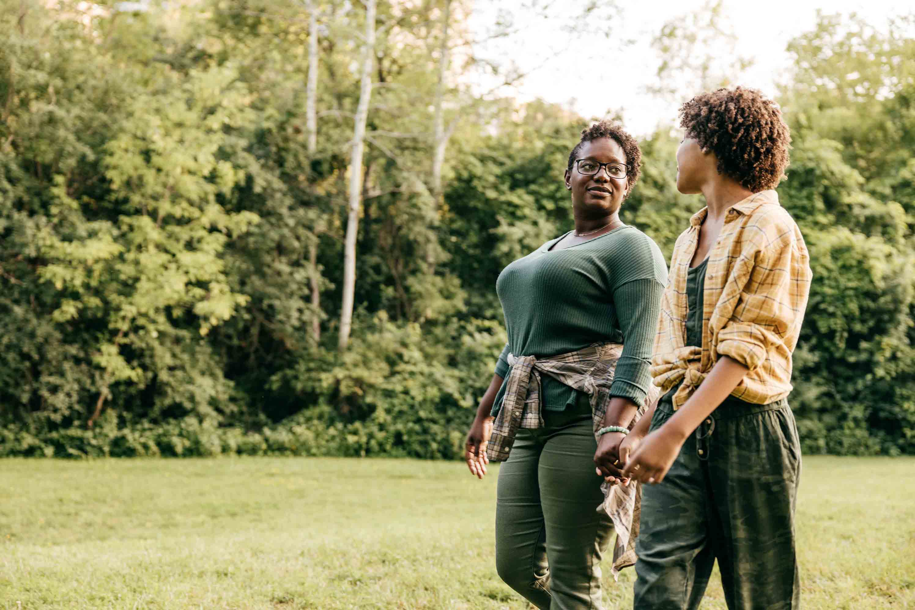 Parent and child walking outside and talking