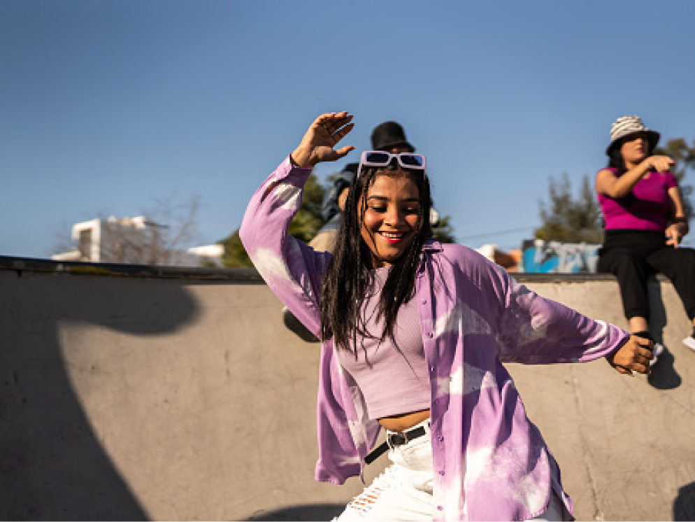 Person dancing having fun at skate park.