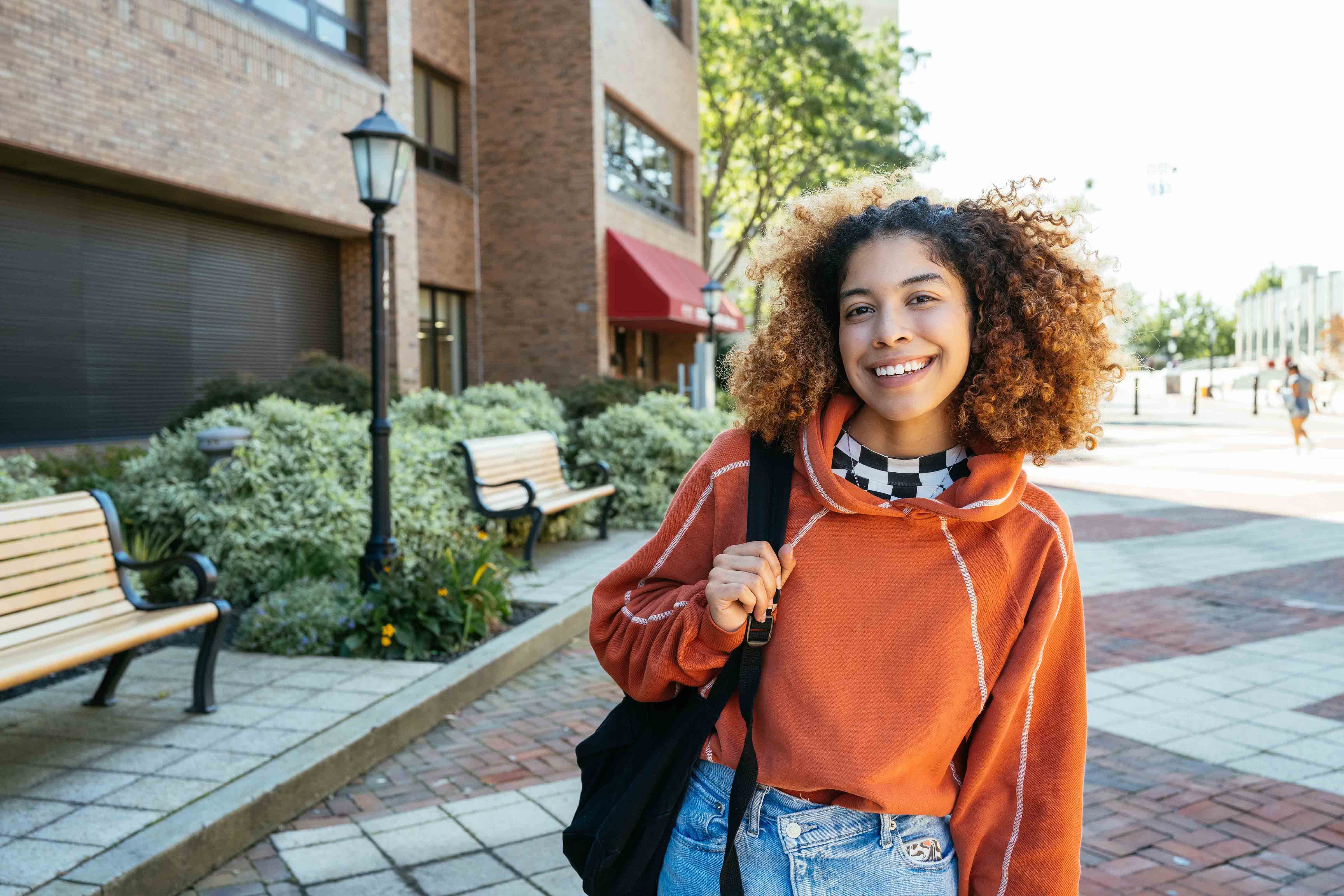 Student smiling on campus.