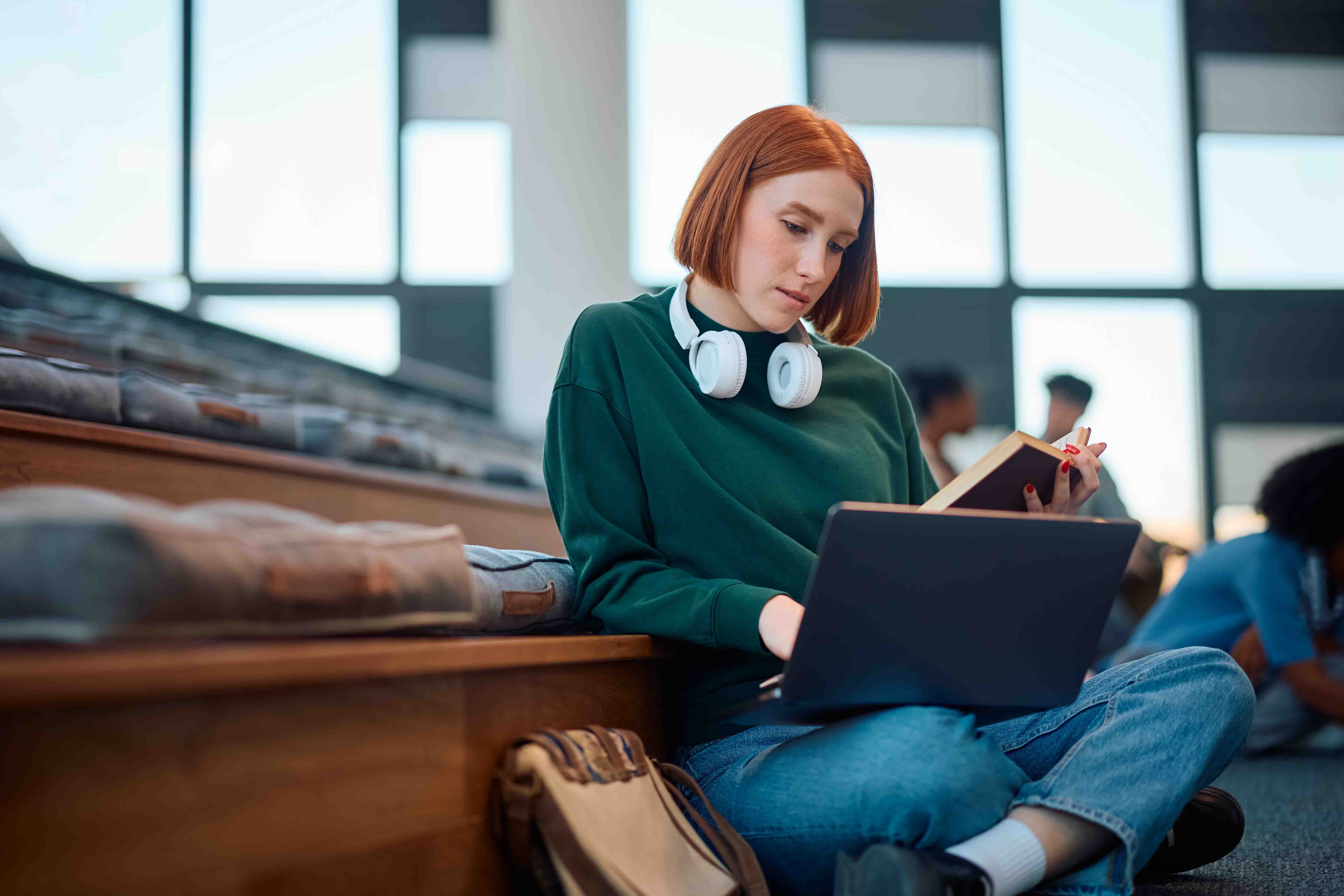 Student reading and typing in lecture hall