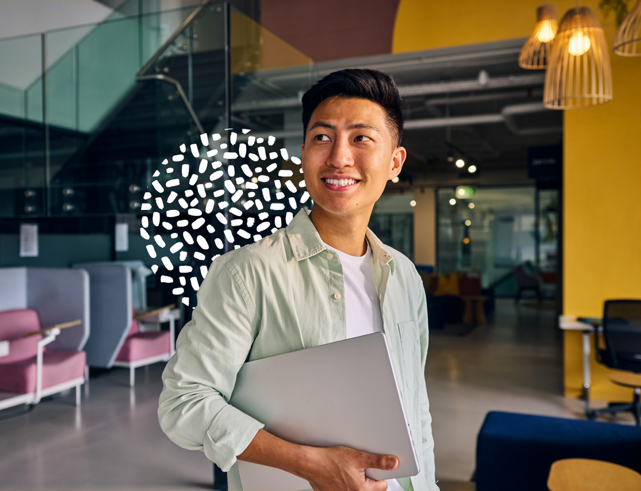 Confident student in shared space with laptop