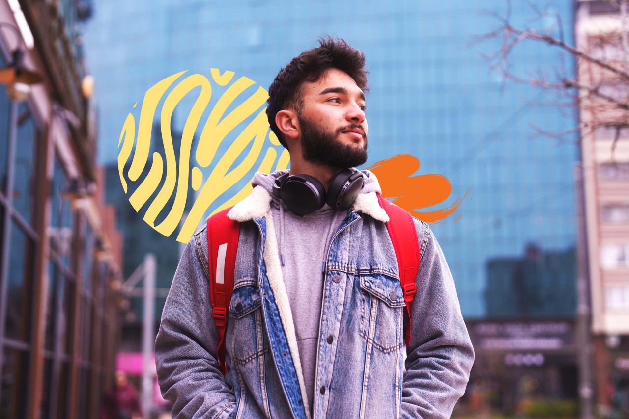 Young adult walking to class in the city in the late afternoon.