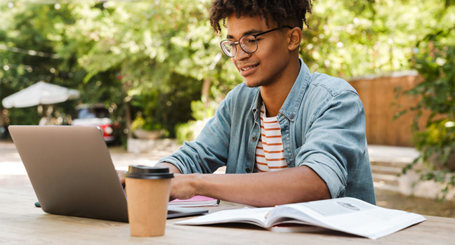 Smiling young African American male student studying