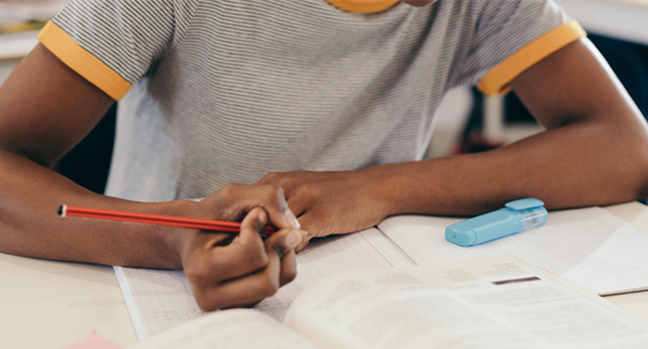 Student taking notes in class