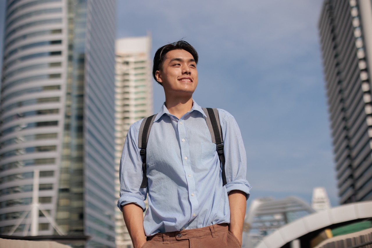 Confident young adult walking to job in the city.